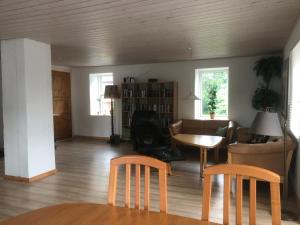 a living room with a couch and a table and chairs at Købmandsgården 4 in Sæby