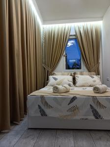 a bedroom with a large bed with curtains at Cozy apartment with garden in Sarajevo