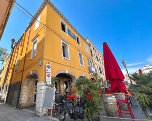 a yellow building with a bike parked in front of it at Airoldi Palace Apartment in Chioggia