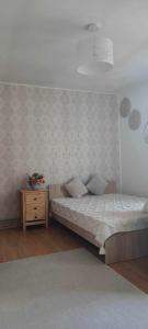 a bedroom with a bed and a night stand at Casa Silvia - Corbu in Corbu
