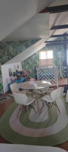 a living room with a table and chairs on a rug at Casa Silvia - Corbu in Corbu +9 photos