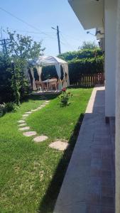 a yard with a tent and a table and chairs at Casa Silvia - Corbu in Corbu