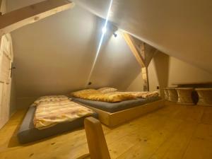 two beds in a room with a attic at EVC Švýcárna in Blansko