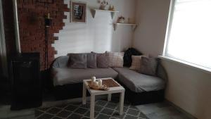 a living room with a couch and a table at Domek w Borach in Nowe