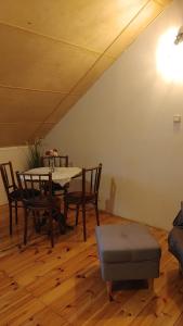 a dining room with a table and chairs and a ceiling at Domek w Borach in Nowe