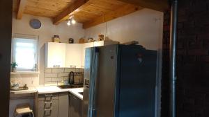 a kitchen with a stainless steel refrigerator in a room at Domek w Borach in Nowe +7 photos