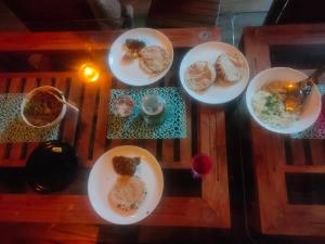 a group of plates of food on a table at Dhara Dhvani Getaway Homes in Tindummal