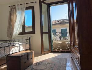 a room with a balcony with a door and a window at Villa bifamiliare per famiglie con giardino. in Cavallino-Treporti