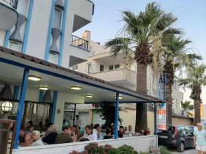 a group of people sitting outside of a restaurant at Sevo Hotel in Ayvalık