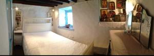a bedroom with a white bed in a room at Patmos Chora with a View in Patmos