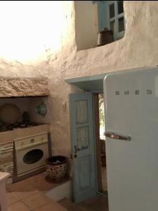 a small kitchen with a refrigerator and a stove at Patmos Chora with a View in Patmos