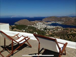 two chairs sitting on top of a roof at Patmos Chora with a View in Patmos