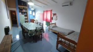 a room with a table and a table and chairs at Cabañas en Koslay Ñalala Ivoqué con piscina climatizada en épocas cálidas in Juana Koslay 