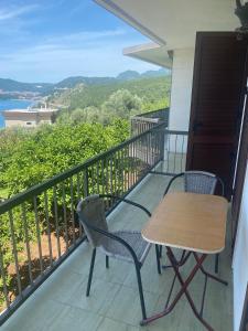 a table and chairs on a balcony with a view at green olive 2 in Budva