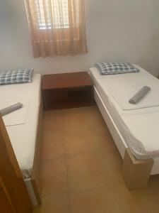 two beds sitting next to each other in a room at green olive 2 in Budva