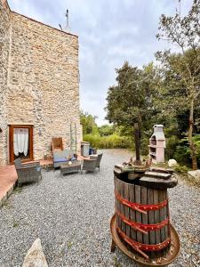 a patio with furniture and a brick building at Hostdomus - Fuggi nel Verde in Finale Ligure