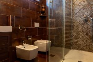 a bathroom with a toilet and a glass shower at Zen Home Zone in Florence