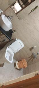 a bathroom with a toilet and a sink at Hotel Zen in Khajurāho