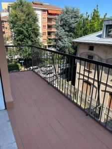 a balcony with a black railing and a building at M&M BERGAMO CENTER - Modern flat with FREE WIFI - Rent BIKE in Bergamo