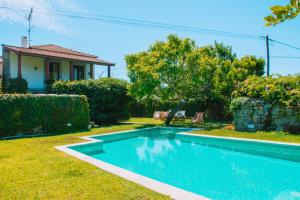 a swimming pool in the yard of a house at Just Like Home - Casa do Cruzeiro in Moledo