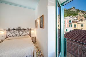 Postel nebo postele na pokoji v ubytování Amalfi un po’...