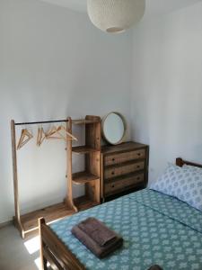a bedroom with a bed with a mirror and a dresser at Perivoli House in Kalymnos +5 photos