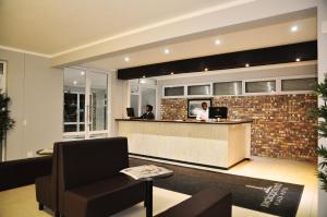 two people sitting at a bar in a lobby at Swakopmund Plaza Hotel in Swakopmund