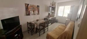 a living room with a table and chairs and a television at VuBra in Ulcinj