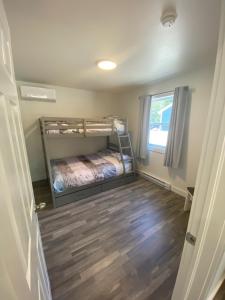 a small bedroom with a bunk bed and a window at The Hideaway Cottage with Private trails in Waweig