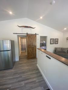 a kitchen and living room with a sliding barn door at The Hideaway Cottage with Private trails in Waweig +17 photos