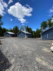 a large gravel parking lot with two houses at The Hideaway Cottage with Private trails in Waweig