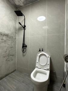 a bathroom with a toilet and a shower at Nature Fruit Farm - Private Estate in Balik Pulau