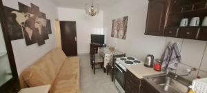 a small kitchen with a sink and a stove at VuBra in Ulcinj