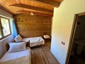 a room with two beds and a window at Aleksander bjeshka in Theth
