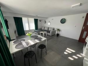 a living room with a table and a couch at Apartament Koninki in Poręba Wielka