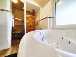 a large white bath tub in a bathroom at Seeschwalbe 329 in Mirow