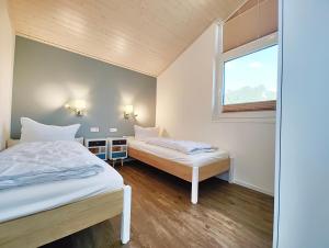 a bedroom with two beds and a window at Seeschwalbe 329 in Mirow