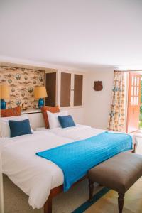 a bedroom with two large beds with blue pillows at Just Like Home - Casa do Cruzeiro in Moledo +46 photos