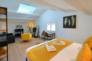 a bedroom with a bed and a living room at Entre 2 eaux in Marseillan