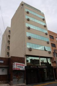 a tall building with a hotel entrance at Hotel Almanara in Rio Grande