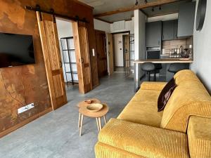 a living room with a couch and a table at Loft House klimatyzowany Apartament - Jezioro Nyskie, Nysa in Nysa
