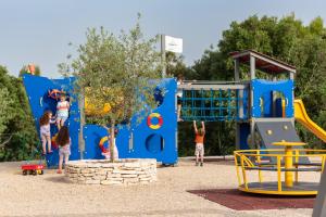 a group of children playing in a playground at Mirana Luxury Villas in Kavran