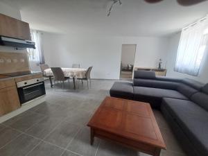 a living room with a couch and a table at T2 Concoules - Panorama, Randonnées, Etapes motards in Concoules
