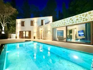 a large swimming pool in front of a house at Domenico Morani Luxury Villa Concept with private pool by DadoVillas in Gastourion