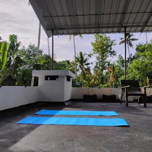 a group of blue mats sitting on a patio at Blue Cove Villa Varkala in Varkala +6 photos