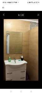 a bathroom with a sink and a mirror at Odessa Mama in Bijela