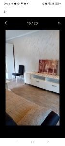 a bedroom with a white bed and a chair at Odessa Mama in Bijela