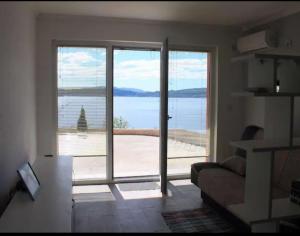 a living room with a large sliding glass door at Odessa Mama in Bijela