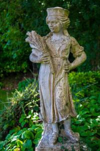 a statue of a statue of a woman in a garden at Cumbria Grand Hotel in Grange Over Sands