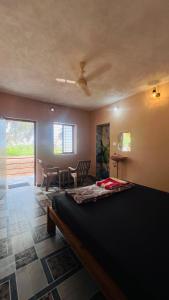 a bedroom with a bed and a dining room at Nakshatra Beach Stay in Gokarn